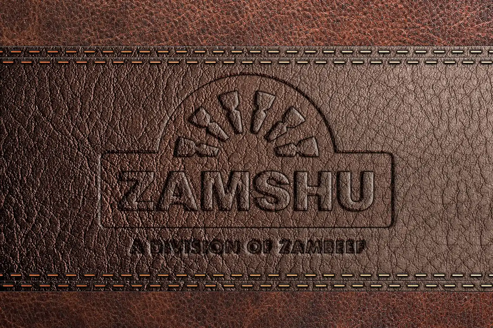 The ZAMSHU logo debossed into brown leather with stitched edges.