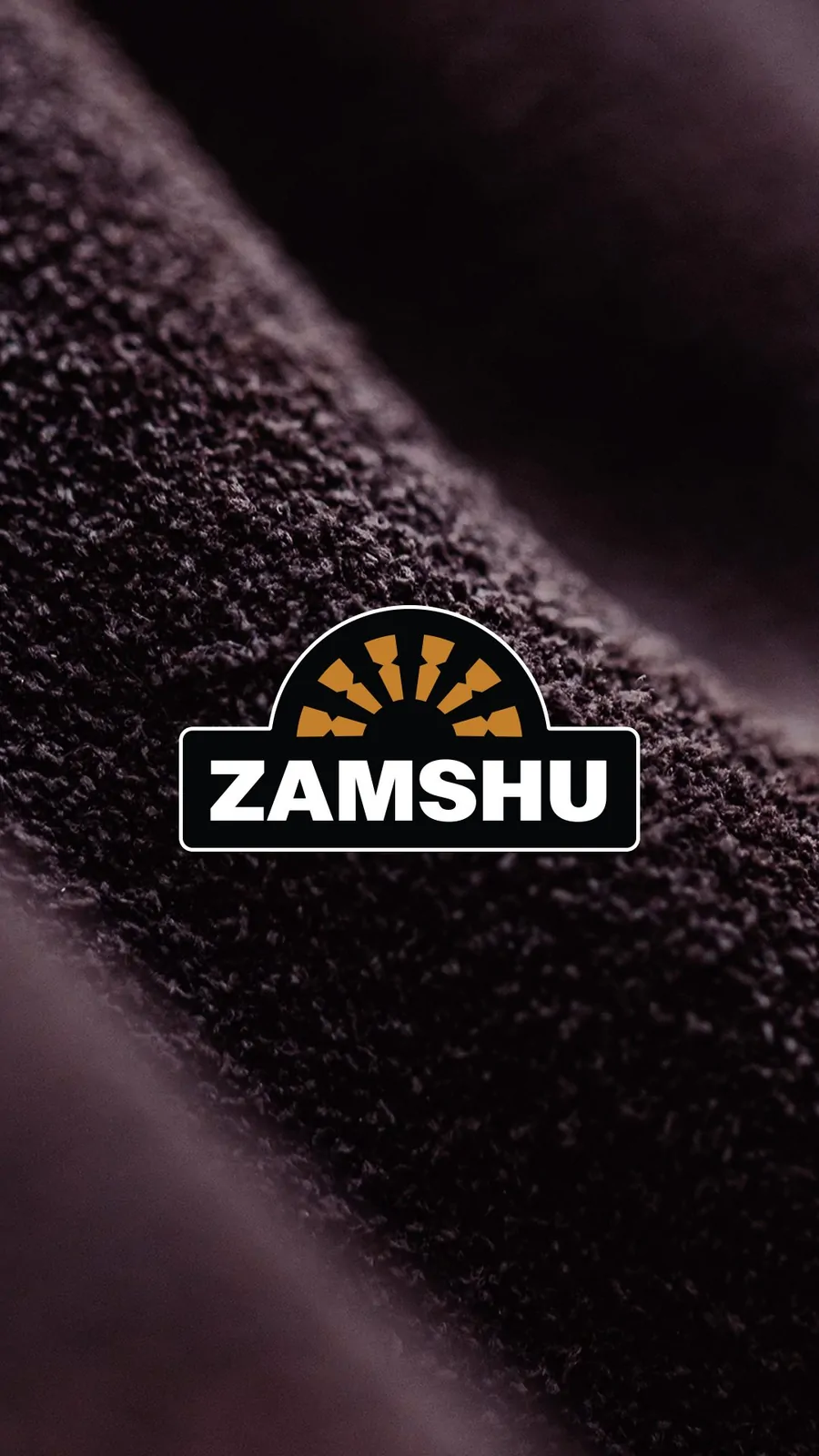 Vertical social post: the keylined ZAMSHU logo over a close-up of dark suede.