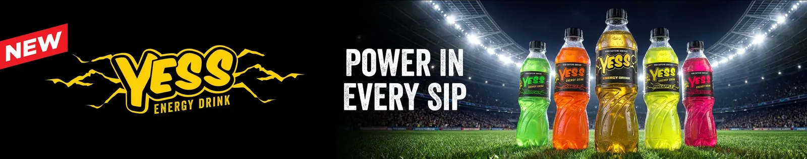 Wide gantry artwork: YESS logo, Power in every sip and the five-bottle lineup on a stadium pitch.