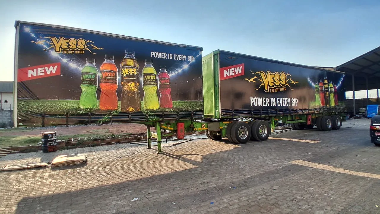Two YESS-wrapped trailers parked side by side.