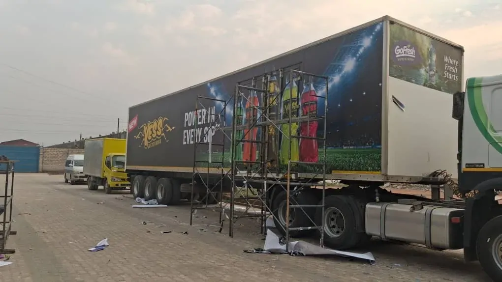 Scaffolding beside a trailer as the YESS wrap is applied.