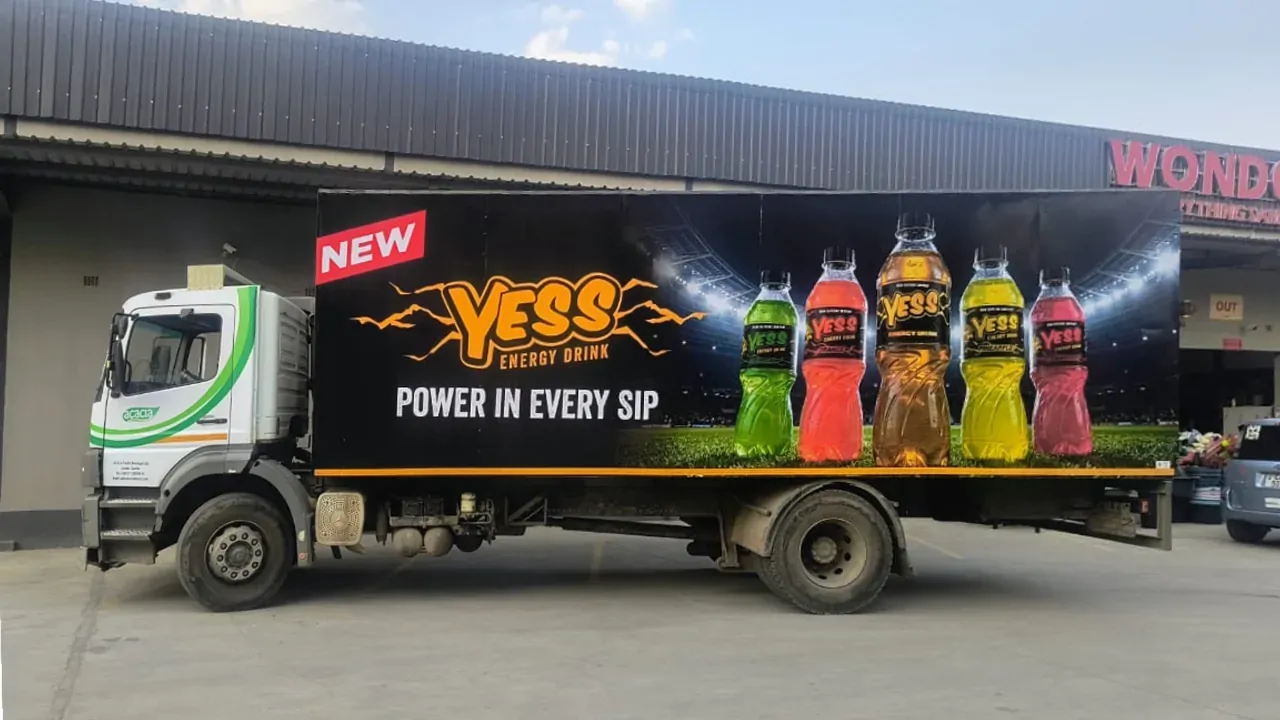 Delivery truck with a YESS Power in every sip box body, parked at a warehouse.