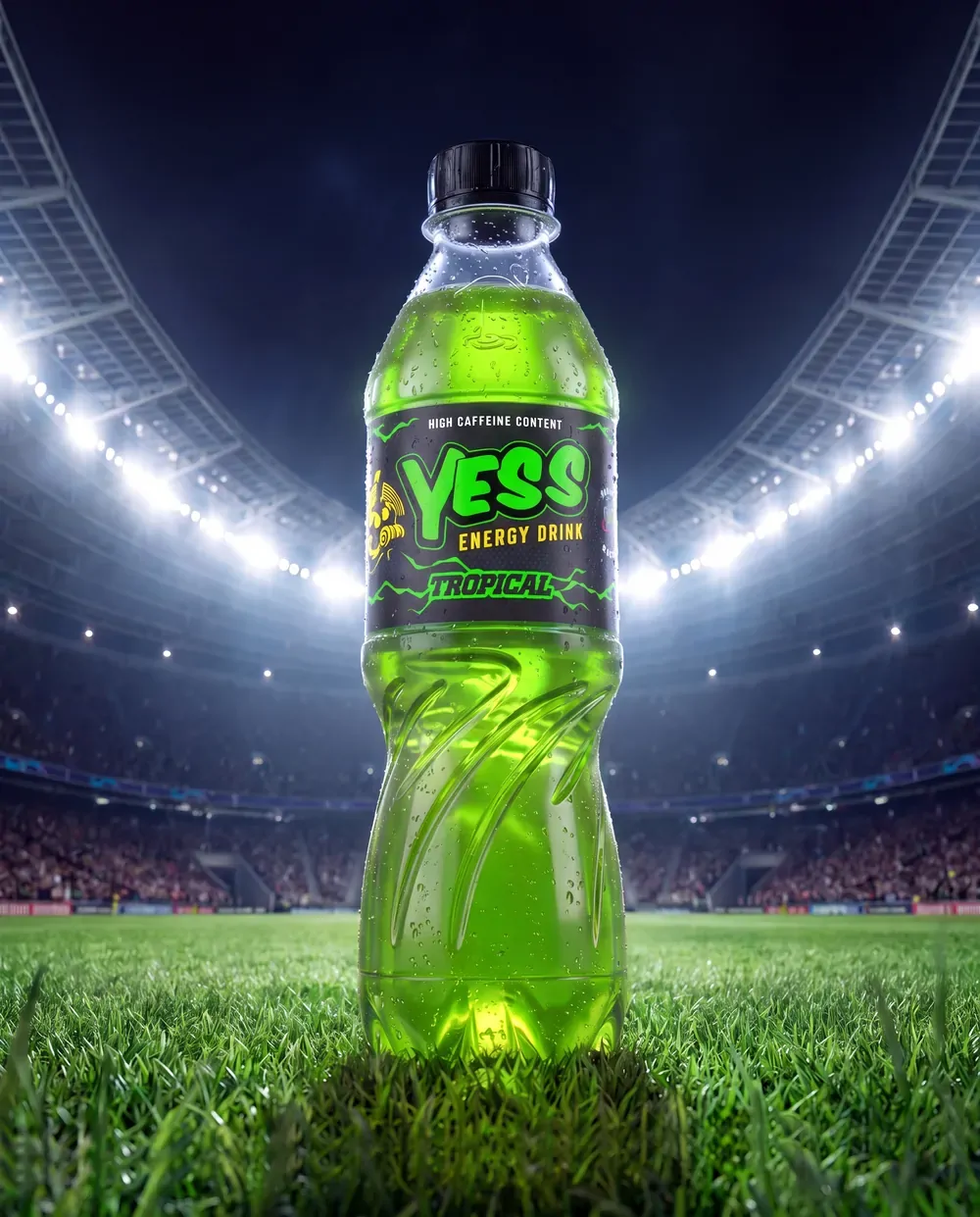 A YESS Tropical bottle on a floodlit stadium pitch.